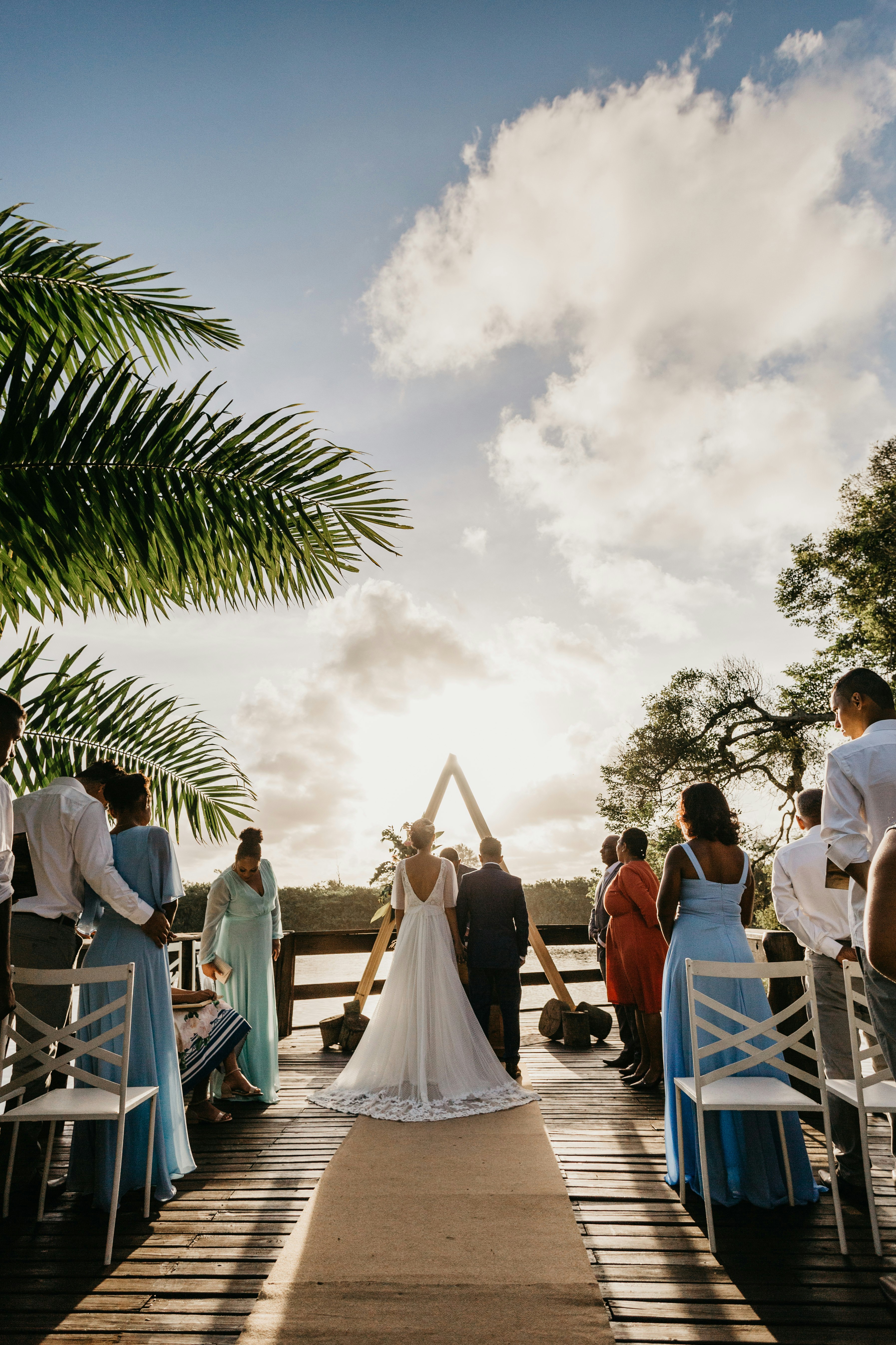 people sitting on white chairs under white clouds during daytime